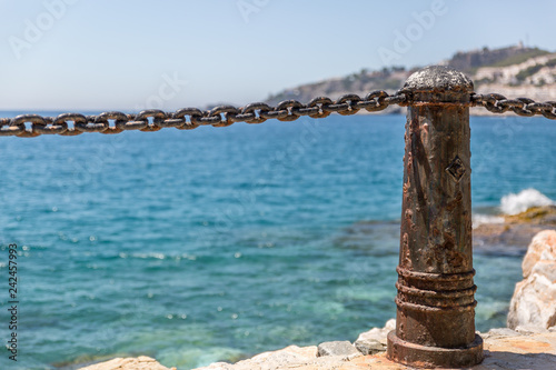 Metal bollards and chains to make a barrier on a beautiful beach in southern Spain, Almunecar