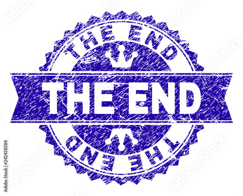 THE END rosette seal overlay with grunge effect. Designed with round rosette, ribbon and small crowns. Blue vector rubber watermark of THE END text with grunge texture.