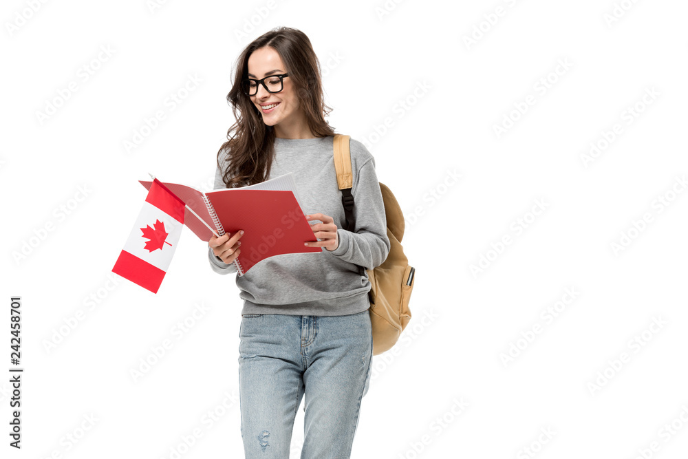smiling female student with backpack holding canadian flag and notebook isolated on white smiling female student with backpack holding canadian flag and notebook isolated on white