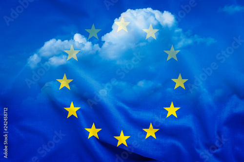 Half-transparent EU flag with white clouds