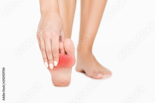 Pain in foot. Woman touching red hurt zone © Prostock-studio