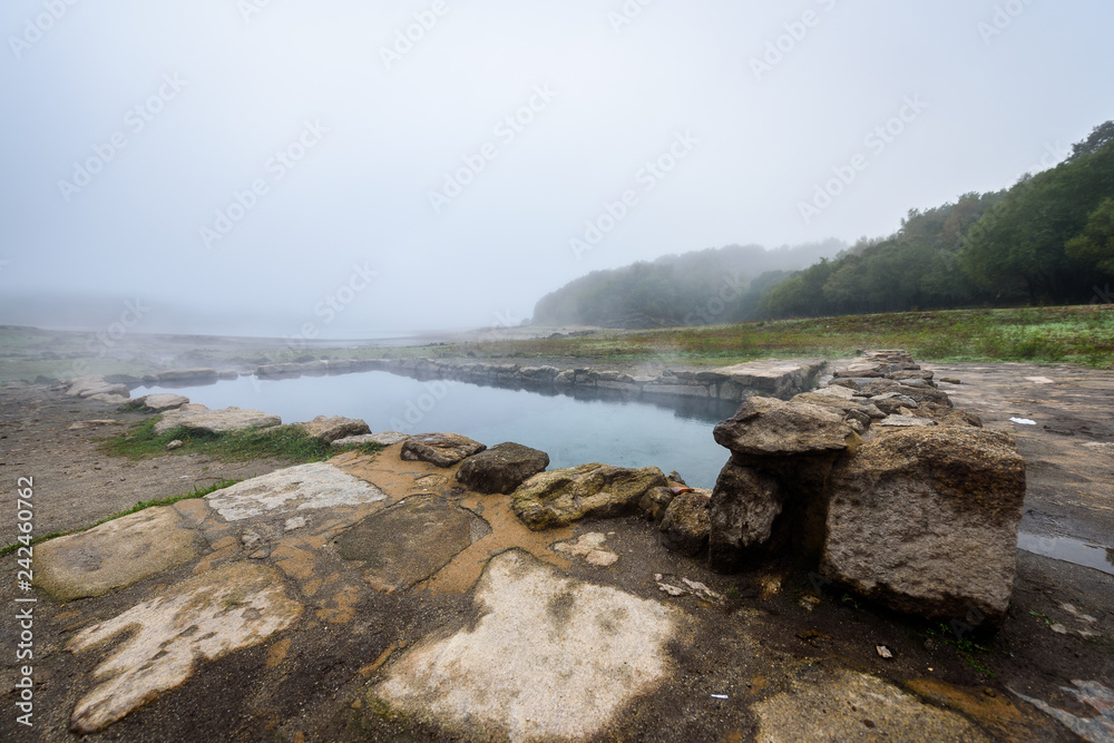 Natural Roman baths outdoors with hot steam and thermal water. Natural Roman baths outdoors with hot steam and thermal water.