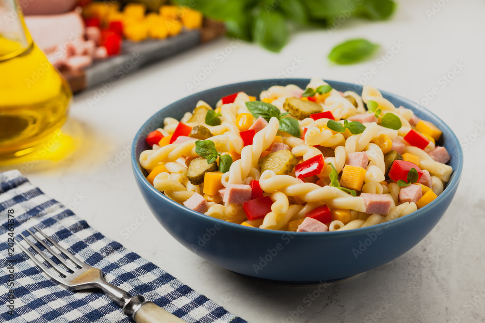 Italian fusilli pasta in a salad with ham and vegetables. Italian fusilli pasta in a salad with ham and vegetables.