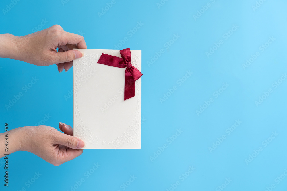 A young woman is giving a gift card with greeting messgae, concept of holiday and celebrate for festival surprising, copy space, top view A young woman is giving a gift card with greeting messgae, concept of holiday and celebrate for festival surprising, copy space, top view