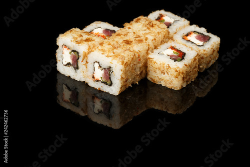 various sushi, rolls on a black background with reflection. especially for cafes and restaurants