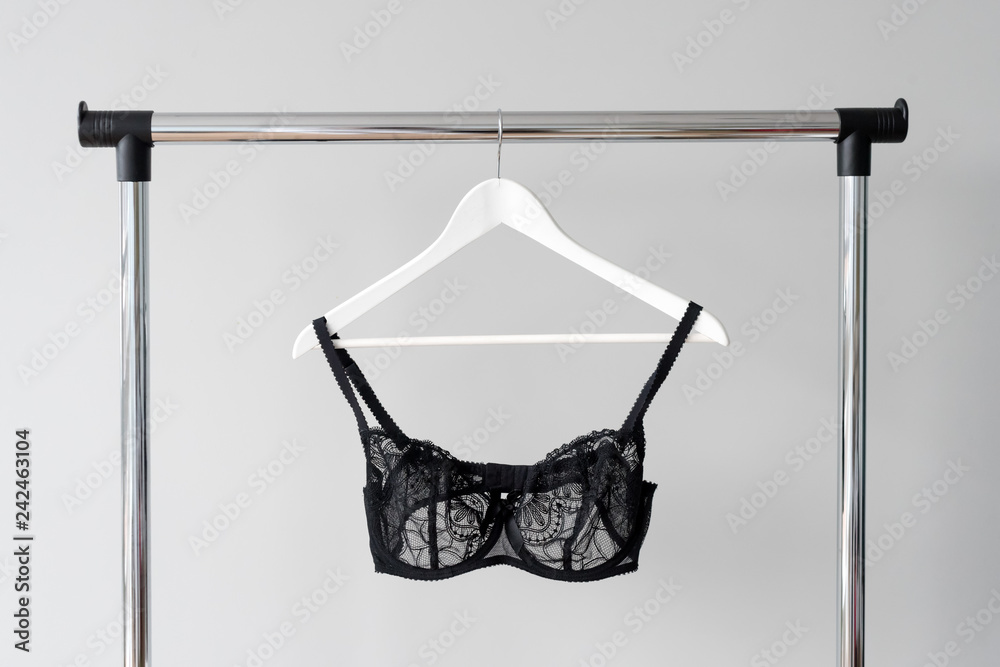 Holding A Lacy Black Bra In The Store On A Hanger Stock Photo