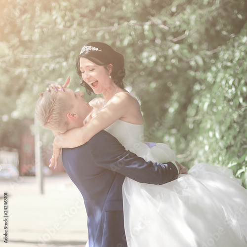 funny bride and groom embracing on the street