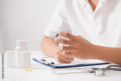 Young man with pills and glass of water at home  closeup