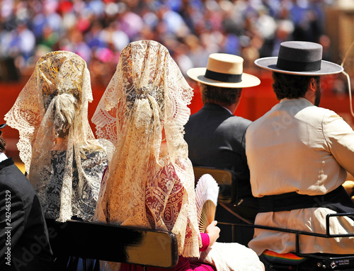 Women with typical spanish lace shawl (mantilla) in a horse carriage at the April Fair in Seville, Spain