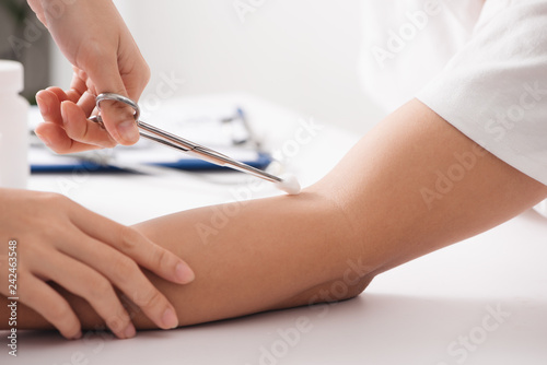 Nurse takes blood from the veins