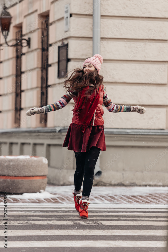 Beautiful model in a winter hat, winter mood, girl at a pedestrian crossing, street shooting, smiling model Beautiful model in a winter hat, winter mood, girl at a pedestrian crossing, street shooting, smiling model