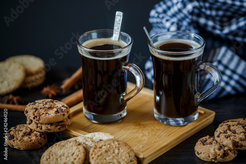 Two cups of coffee and chocolate and oatmeal cookies