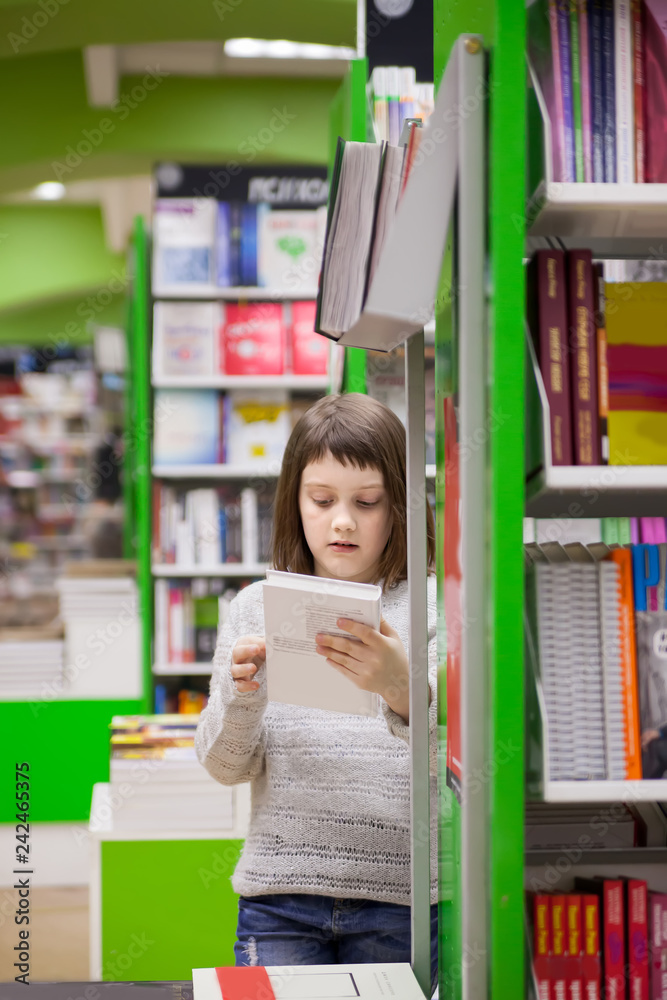 girl of 8 years choosing books in bookstore girl of 8 years choosing books in bookstore