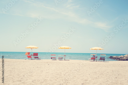 Three Umbrellas and Chairs at sandy beach in Durres, Adriatic Sea shore of Albania
