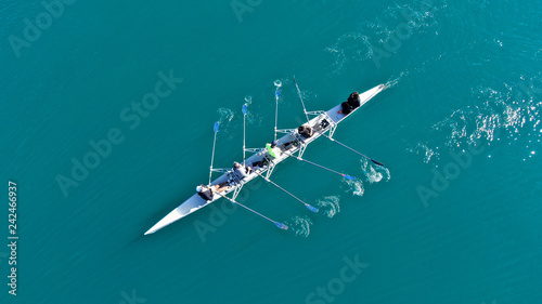 Fotografija Aerial drone bird's eye view of sport canoe operated by team of young men in ope