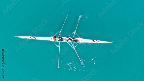 Aerial drone bird's eye view of sport canoe operated by young fit man in turquoise clear waters © aerial-drone