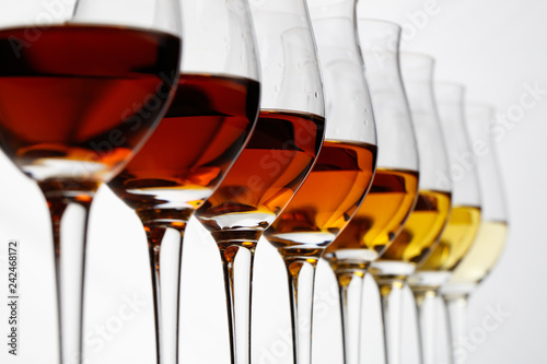Row of cognac glasses with different stages of aging
