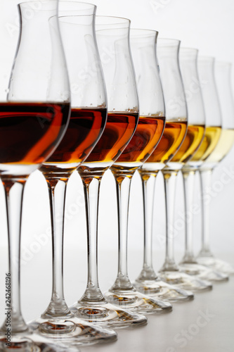 Row of cognac glasses with different stages of aging
