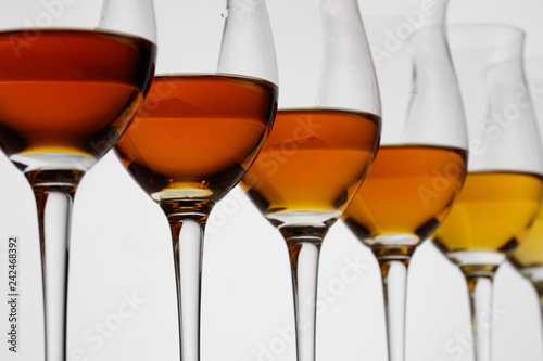 Row of cognac glasses with different stages of aging