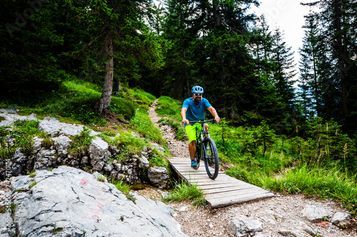 Tourist cycling in Cortina d'Ampezzo, stunning rocky mountains on the background. Man riding MTB enduro flow trail. South Tyrol province of Italy, Dolomites. © Gorilla