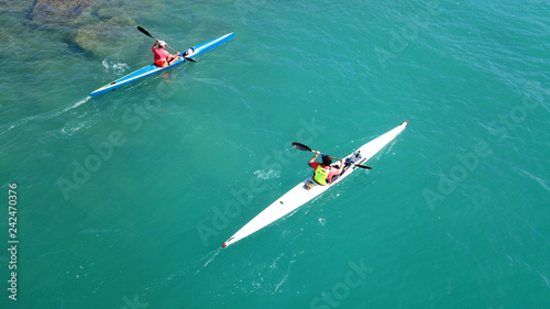 Aerial drone bird's eye view of sport kayak operated a young men in tropical exotic turquoise clear ocean