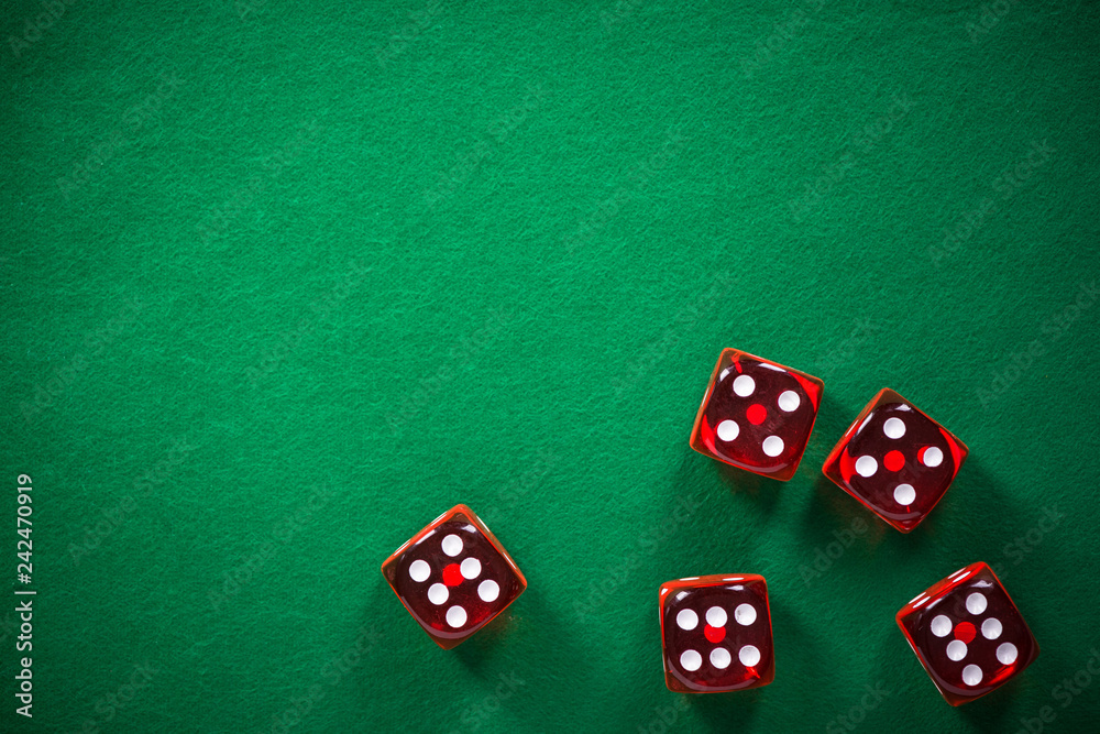 Red poker dices on green casino felt, spotlight background Red poker dices on green casino felt, spotlight background