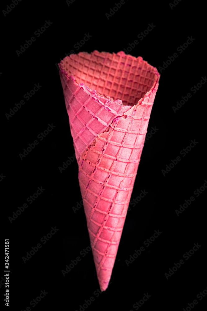 Pink empty wafer cone on dark background Pink empty wafer cone on dark background