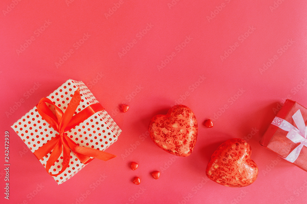Valentines day background with red hearts and a gift in box, top view Valentines day background with red hearts and a gift in box, top view