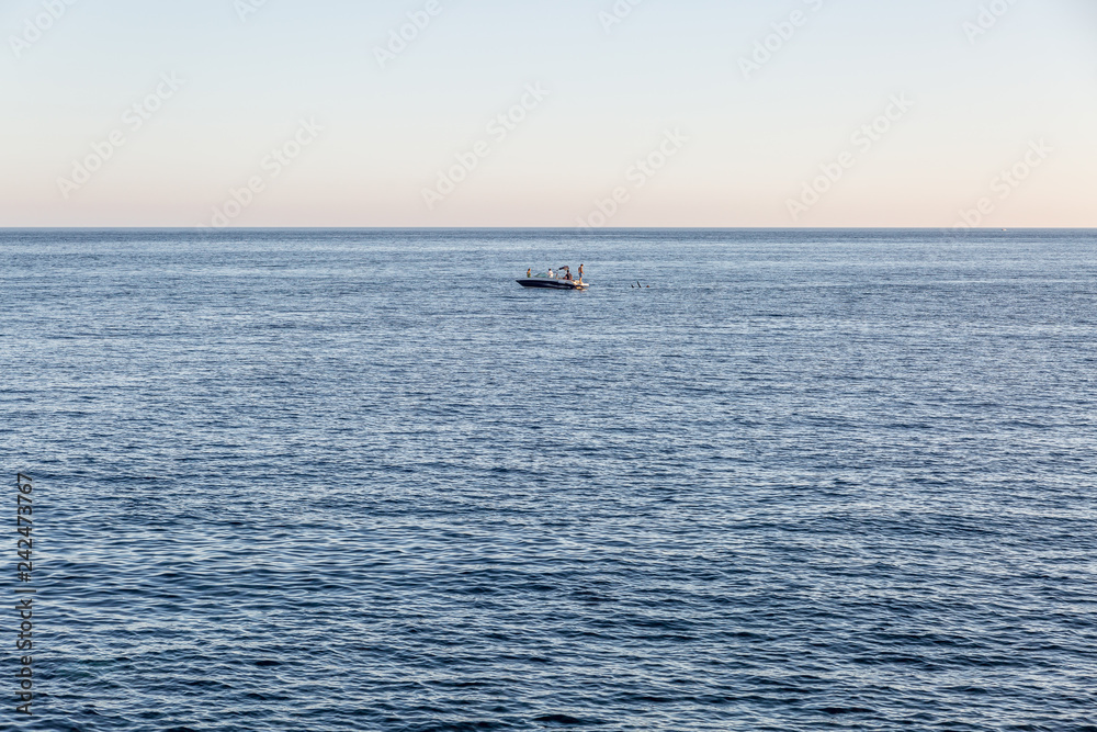 Distant view of a lone boat in the middle of the sea