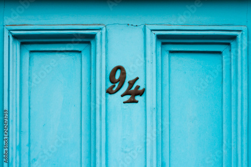 House number 94 on a blue or turquoise front door