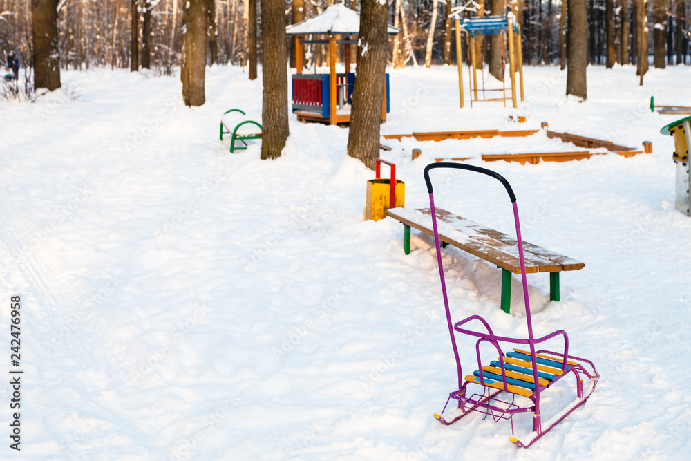 snow-covered playground in urban park in winter snow-covered playground in urban park in winter