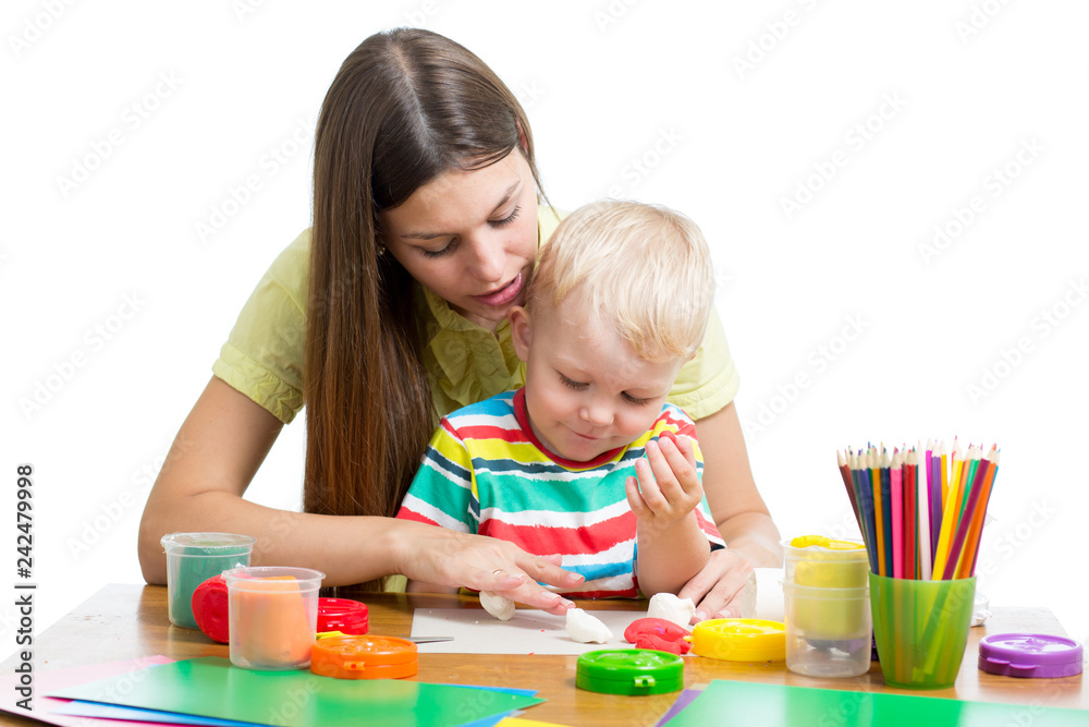 Young woman playing with her boy with plasticine isolated on white background Young woman playing with her boy with plasticine isolated on white background