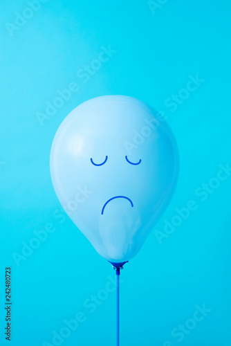 blue balloon with a sad face photo