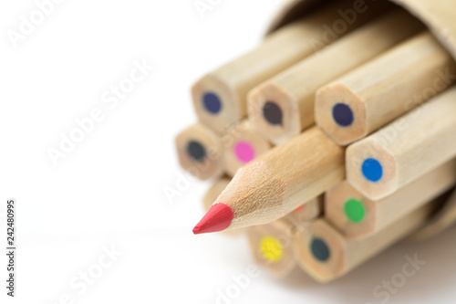 Red pencil standing out from crowd on white table. Leadership, uniqueness, independence, initiative, strategy, dissent, think different, business success concept.