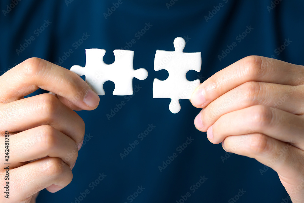 Hands connecting jigsaw puzzle. Business solutions, success and strategy concept. Hands connecting jigsaw puzzle. Business solutions, success and strategy concept.