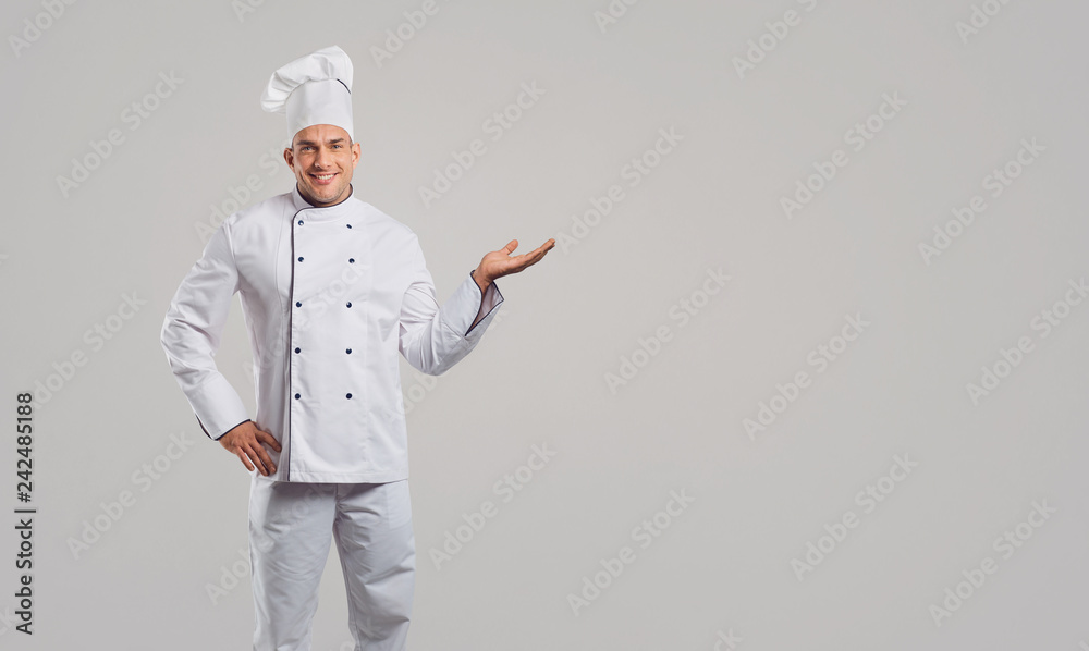 Chef in a white uniform makes a gesture.