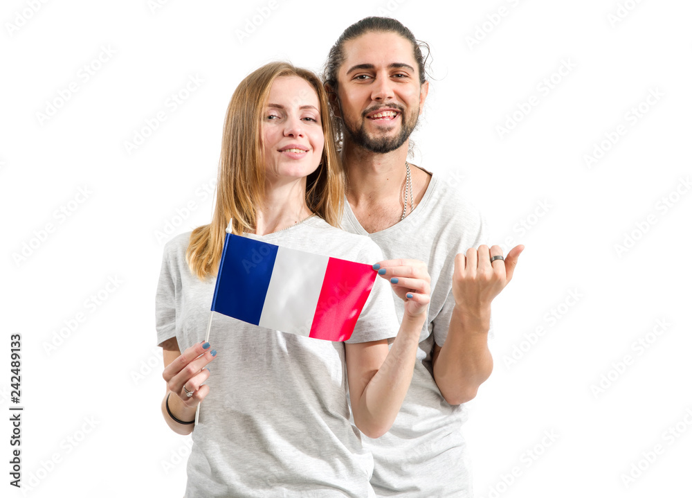 Fototapeta premium Happy couple in gray t-shirts with the flag of France isolated on white background. Learn French. Young people, man and woman.