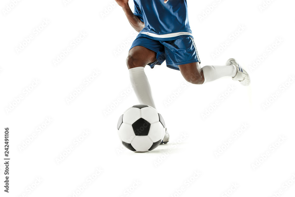 The legs of soccer player close-up isolated on white. African american model in action or movement with ball. The football, game, sport, player, athlete, competition concept
