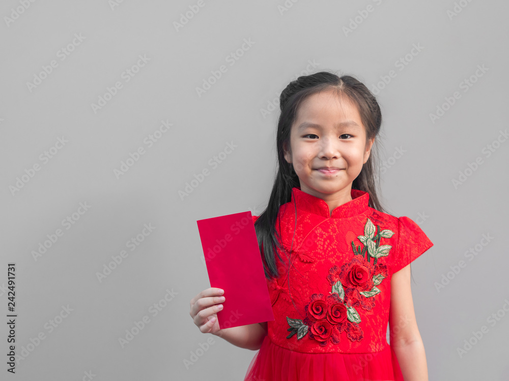 Cute Asian girl in chinese cheongsam and Tradition Chinese dress with red envelope , Chinese new year concept , grey background Cute Asian girl in chinese cheongsam and Tradition Chinese dress with red envelope , Chinese new year concept , grey background