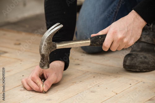Men Using a hammer and nail on wood , renovation concept