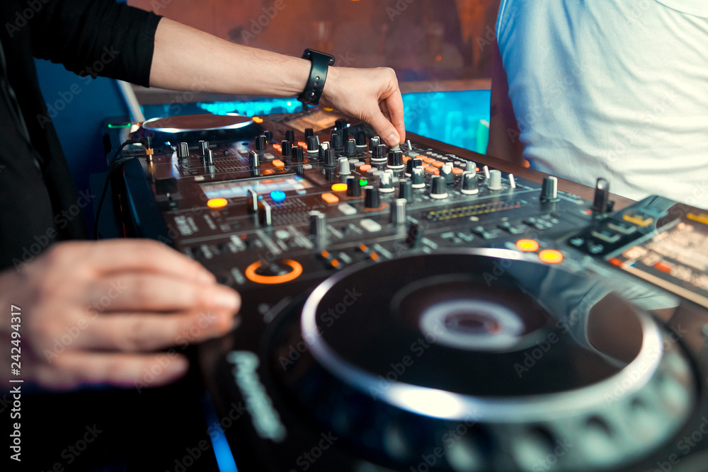 Obraz premium Dj mixes the track in the nightclub at party