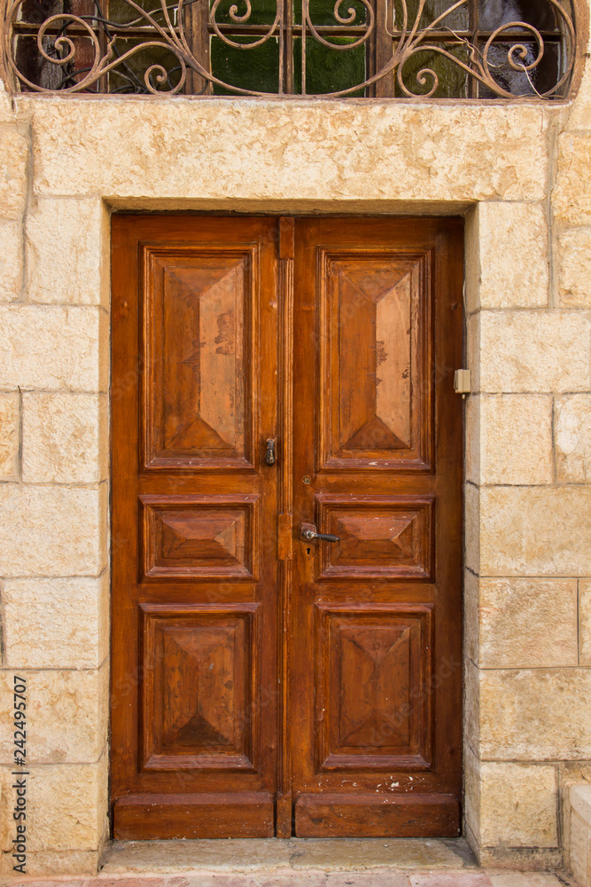 Wooden brown doors in a stone building
