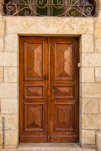 Wooden brown doors in a stone building