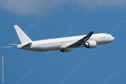 Large passenger white twin-engine widebody aircraft in the sky
