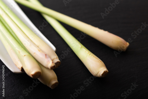 Healthy herb spot focus Lemongrass on black slate stone background with copy space