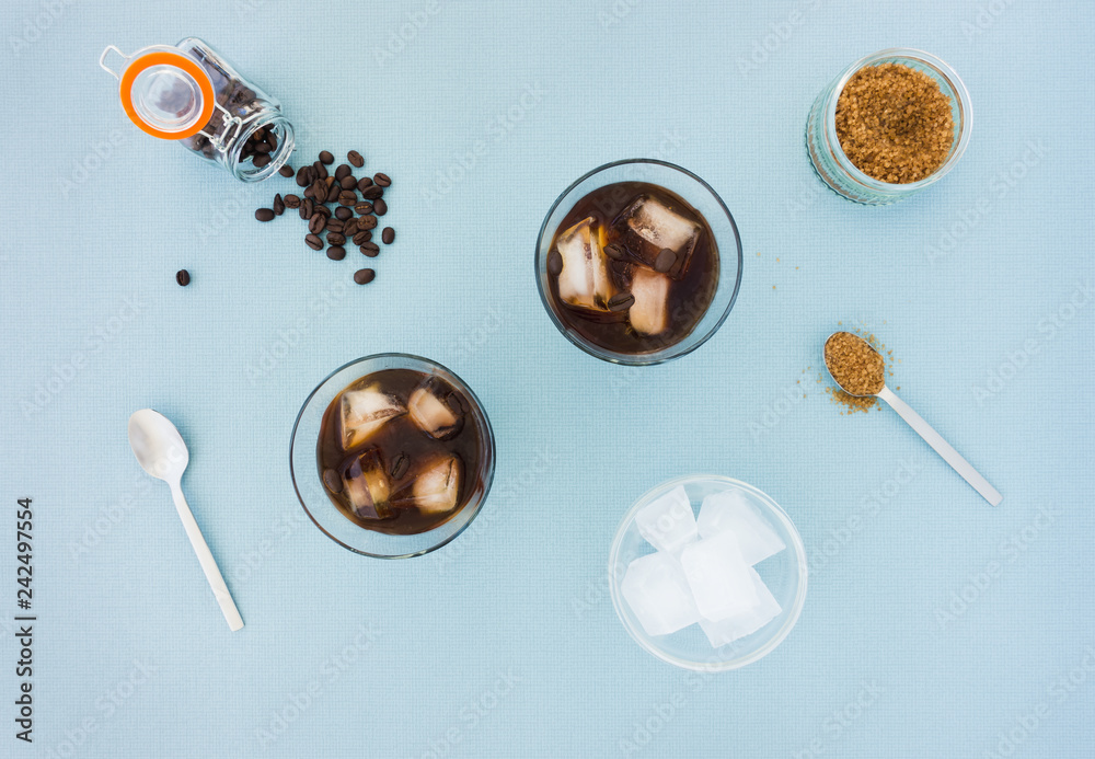 Iced Coffee, Coffee Beans, Sugar and a Bowl with Ice Cubes Iced Coffee, Coffee Beans, Sugar and a Bowl with Ice Cubes