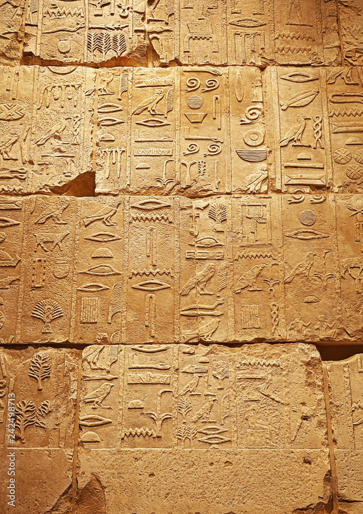 Stone wall with ancient Egyptian hieroglyphs