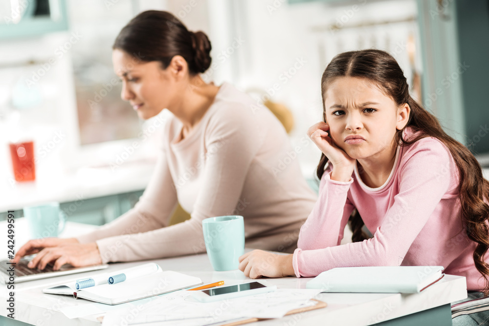 Negative delighted kid being bored at home Negative delighted kid being bored at home