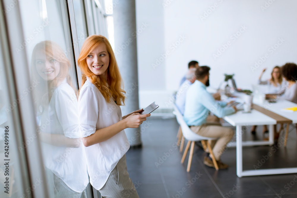 Pretty young red hair woman using digital tablet Pretty young red hair woman using digital tablet