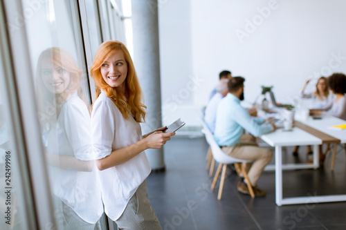 Pretty young red hair woman...